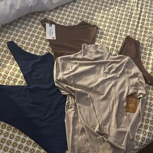 Three bodysuits blue sleeveless . Tan mid turtleneck, brown sexy all size large